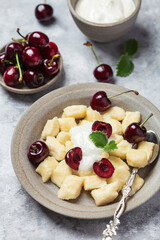 cottage cheese dumplings with sour cream and cherries