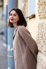 Woman in black pantsuit walks on promenade