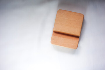 Wooden stand for mobile phone isolated on white background 