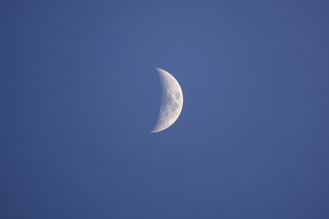 Obraz na płótnie Canvas A growing moon in a clear sky on a winter day.