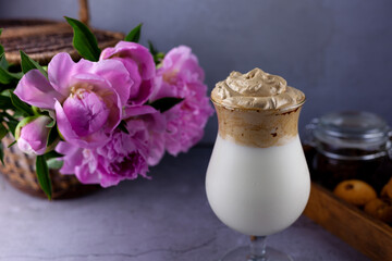 Milk shake. Chocolate and coffee sweet chilled ice-cream drink. Summer drink on the table in a glass goblet on a leg. Bar drinks.