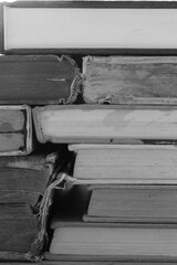 Black and white of many old books overlapping selective focus and shallow depth of field