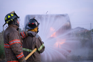 Firefighters fight against the raging fire from the fuel tank.