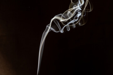 abstract beautiful fragment movement of burn white smoke on black background.