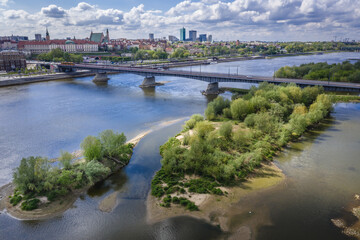 Bridge over River Vistula and Old Town of Warsaw, capital city of Poland - drone view from  Praga Polnoc area