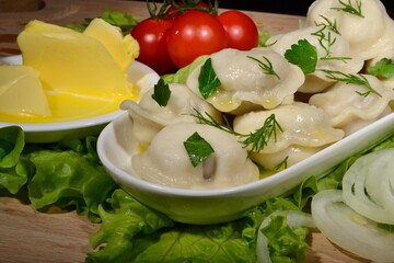 dumplings with butter, tomato and herbs