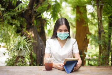 Beautiful woman is wearing face mask in coffee shop