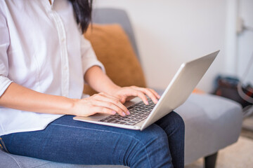 Woman hands typing on laptop keyboard at the home, Woman worker and business concept.