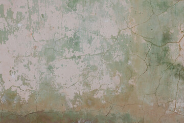 Old grungy concrete wall with peeling paint