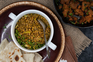 vegan lentil and celery stew served with flat breads and roasted seitan
