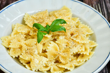 Farfalle pasta  cacio e pepe , olive oil,parmesan cheese, black pepper  and fresh onion. Vegetarian home made italian pasta