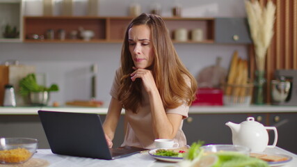 Businesswoman typing on laptop at home workplace. Woman working on laptop