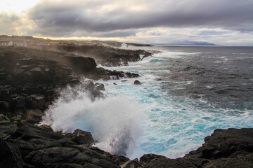 Wild seascape at Pico, Azores, Portugal, with black lava rocks on the coast