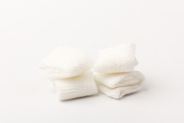 White gauze pads on white background. Materials for dental surgery. Close up