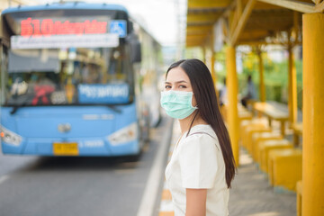 Beautiful woman is wearing face mask in bus stop