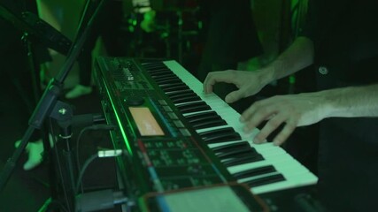 Pianist Musician Performs Live Keyboard Game In A Band. A musician plays a synthesizer in a musical group.
