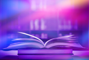 Stack of books in the library and blur bookshelf background	
