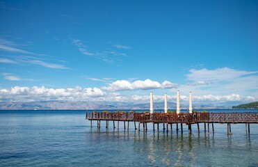 Wooden pier with cafe in Ionian sea. Greece.