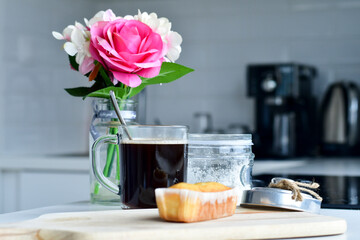 still life with a rose and a cup of  coffee and plumcake