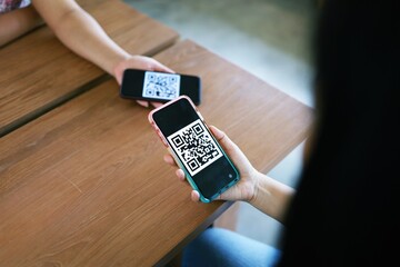 Qr code payment. Woman scanning QR code online shopping cashless technology concept.