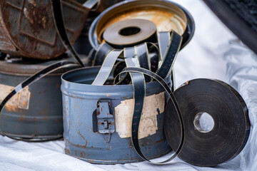 Used round metal boxes with old film. 35 mm film in a roll and in boxes. retro cinematic mockup.