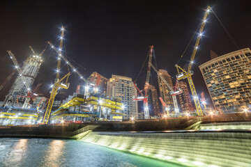 Fototapeta na wymiar Amazing night view of under construction skyscrapers in Dubai