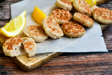 Home made italian  chicken  meatballs  with parmesan cheese, chily peppers and fresh  lemon on  rustic background. Diet food.