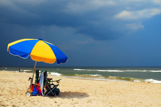 An umbrella is abandonned on Virginia Beach as a storm approaches
