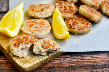 Home made italian  chicken  meatballs  with parmesan cheese, chily peppers and fresh  lemon on  rustic background. Diet food.