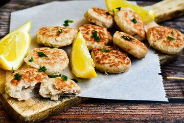Home made italian  chicken  meatballs  with parmesan cheese, chily peppers and fresh  lemon on  rustic background. Diet food.