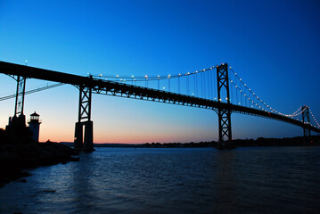 The first light of dawn begins to appear under the Bristol Mt Hope Bridge in Rhode Island