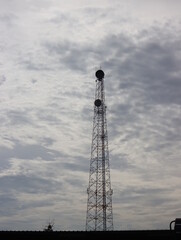 Telecommunications poles on a dimly lit day.