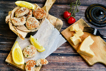 Home made italian  chicken  meatballs  with parmesan cheese, chily peppers and fresh  lemon on  rustic background. Diet food.