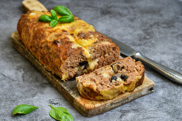 Home made baked  delicious  italian  traditional meatloaf filled  with cheese and mushrooms 