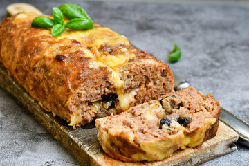 Home made baked  delicious  italian  traditional meatloaf filled  with cheese and mushrooms 