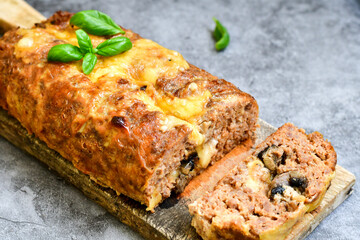 Home made baked  delicious  italian  traditional meatloaf filled  with cheese and mushrooms 