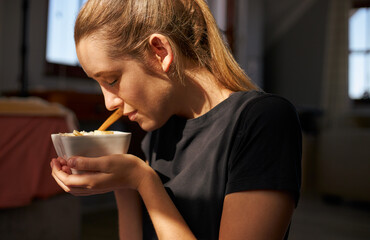 Young female holding healthy breakfast bowl