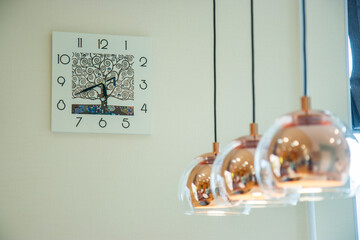 
lights in the office against the background of the wall clock