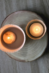 Two candle holders with lit candles. Home decor detail. Top view.