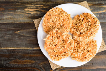 Deep fried sweet crispy rice with cane sugar drizzle, Local Thai snack (Khao Tan)