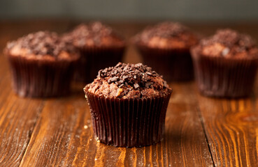 Traditional fresh dessert chocolate muffin on wooden background