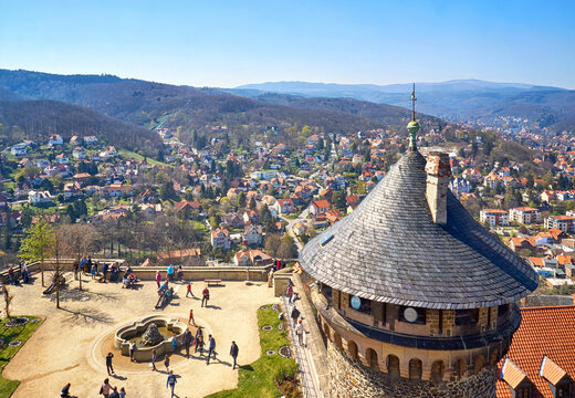 View of the courtyard with tower at Wernigerode Castle with the Harz Mountains and the city in the background. Germany