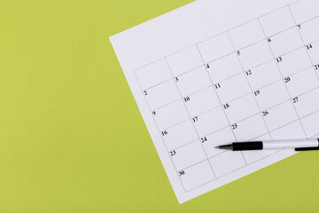 calendar on the table with green background, planning a business meeting or travel planning concept