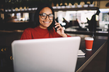 Portrait of afro american student sitting in coffee shop on break looking at camera 