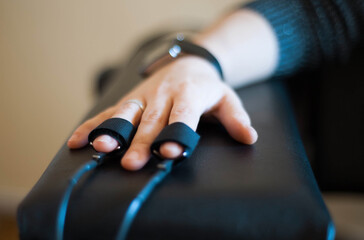woman's hand in a lie detector apparatus close-up