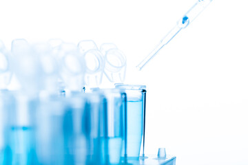 microbiological pipette in the genetic laboratory. study of a virus or vaccination. blue tinted.