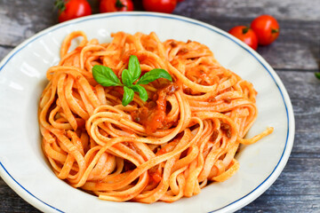 Spaghetti  bolognese .Italian home made meal Fresh  bucatini pasta with tomato sauce, basil, herbs ,parmesan cheese ,fresh cherry tomatoes and parsley on wooden background. Kitchen Poster 