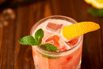 Grapefruit and orange smoothie coctail on grey wooden background. Refreshing drinks