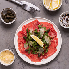 Marbled beef carpaccio with arugula, capers, lemon and parmesan cheese
