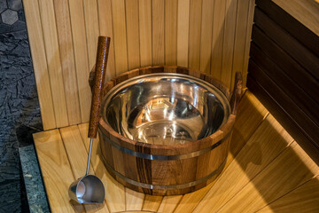 Wooden basin and ladle in new modern sauna